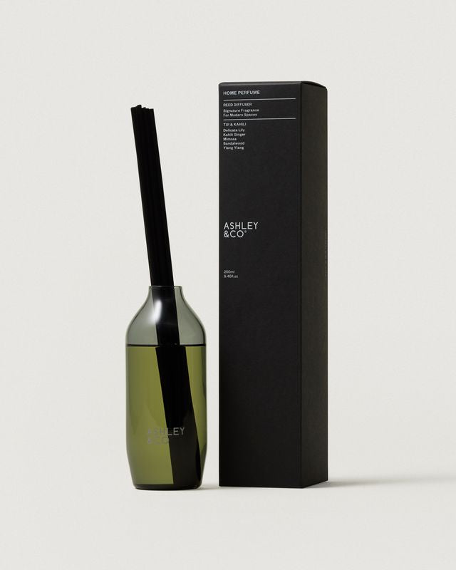 Ashley & Co Home Perfume reed diffuser in Tui & Kahili with green glass vase and black box