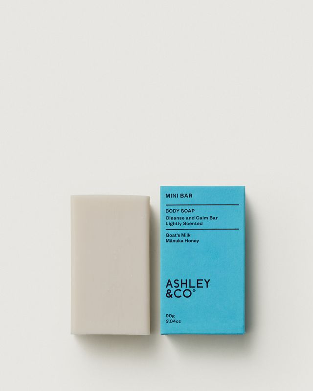Ashley & Co Mini Bar 90g soap with blue packaging and the unwrapped bar